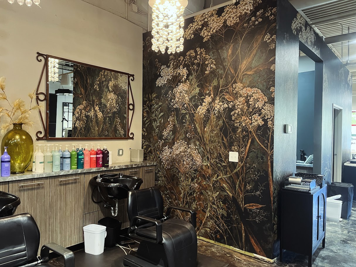 Botanical mural wallpaper beside the salon wash stations